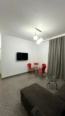 a living room with a bed and a table with chairs at A 2 BR with pool view Hurghada in Hurghada