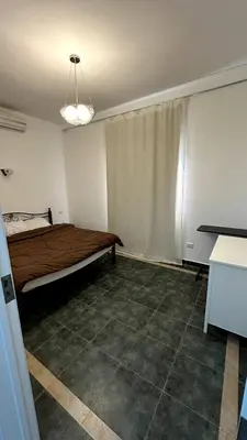 a bedroom with a bed in the corner of a room at A 2 BR with pool view Hurghada in Hurghada