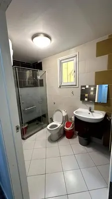 a bathroom with a shower toilet and a sink at A 2 BR with pool view Hurghada in Hurghada