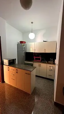 a kitchen with white cabinets and a black counter top at A 2 BR with pool view Hurghada in Hurghada