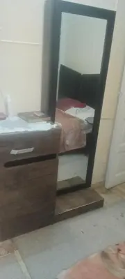 a mirror in front of a bedroom with a bed at شقه ب موقع متميز عل النيل in Maḩaţţat ash Shallāl