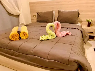 a bed with two flamingos on top of it at Juliana Beach in Hurghada
