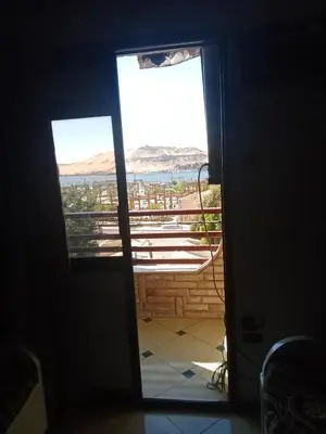 a door leading to a balcony with a view of the ocean at شقه ب موقع متميز عل النيل in Naj‘ al ‘Amrāb