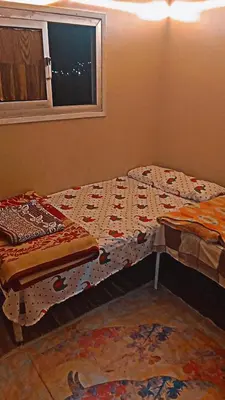 a bed sitting in a room with a window at وسط البلد البلدوزر بجوار مستشفي النيل التخصصي in Aswan