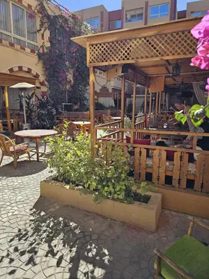 a patio with a table and chairs and flowers at قرية الهمبرا السياحية بالغردقة in Hurghada