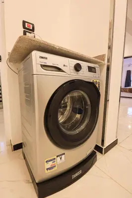 a washing machine with a counter on top of it at Villa Abo Tarek in Al Aqālitah