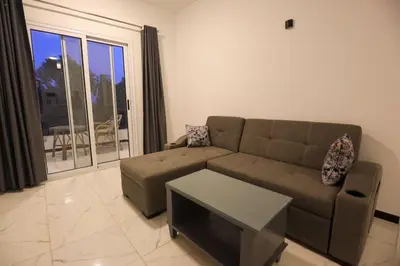 a living room with a couch and a table at Villa Abo Tarek in Al Aqālitah