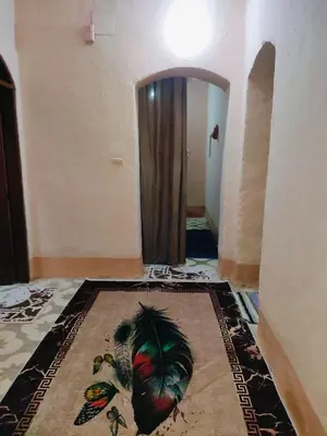 a hallway with a door and a rug on the floor at Sunset Mirage in Luxor