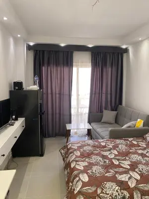 a bedroom with a bed and a couch at Florenza01 in Hurghada