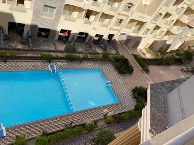 an overhead view of a swimming pool in front of a building at Florenza01 in Hurghada