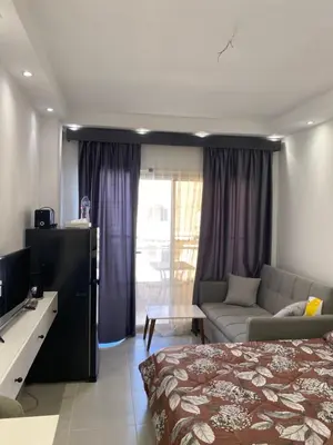 a hotel room with a bed and a couch at Florenza01 in Hurghada