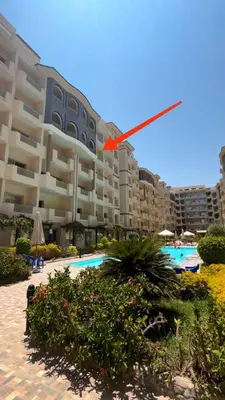 a large apartment building with a red arrow on it at Florenza01 in Hurghada