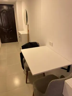 a white table and chairs in a room with a door at Florenza01 in Hurghada