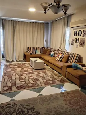 a living room with a couch and a coffee table at Al-Kiam Villa A F in Hurghada