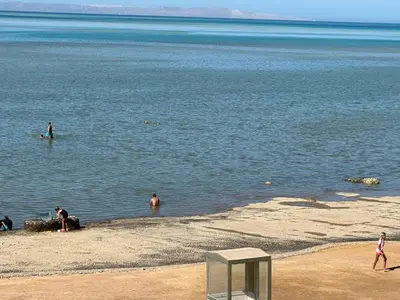 a group of people in the water at the beach at Al-Kiam Villa A F in Hurghada