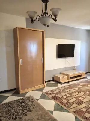 a room with a large wooden door and a flat screen tv at Al-Kiam Villa A F in Hurghada