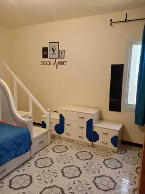 a bedroom with a bed and a dresser and a desk at Al-Kiam Villa A F in Hurghada