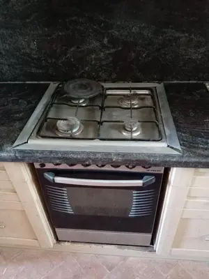 a stove top oven sitting under a counter in a kitchen at Al-Kiam Villa A F in Hurghada