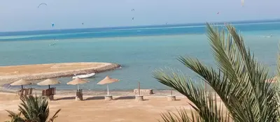 a beach with a group of umbrellas and the ocean at Al-Kiam Villa A F in Hurghada