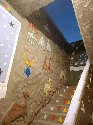 a mural of animals on the side of a wall at Noury kato in Jazīrat ‘Awwāḑ