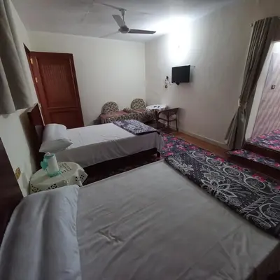 a hotel room with two beds and a television at Remal City in Luxor