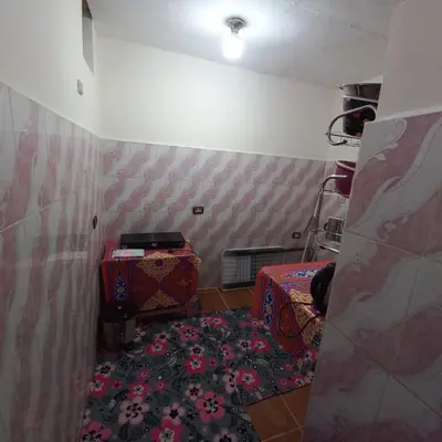 a small room with a bed and a rug at Remal City in Luxor