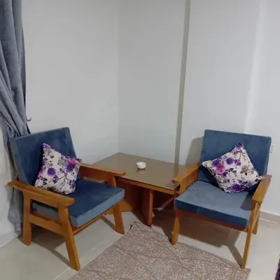 a dining room with two chairs and a table at Tiba Golden -unit102 - Aladauy in Hurghada
