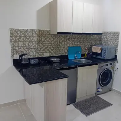 a kitchen with a sink and a washing machine at Tiba Golden -unit102 - Aladauy in Hurghada
