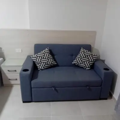 a blue couch in a living room with two pillows at Tiba Golden -unit102 - Aladauy in Hurghada