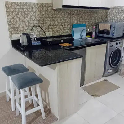 a kitchen with a counter and a washing machine at Tiba Golden -unit102 - Aladauy in Hurghada