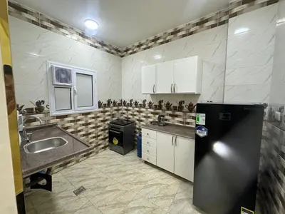 a kitchen with a black refrigerator and a sink at TibaHouse in Luxor