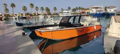 an orange boat is docked in a harbor at Tai Speedboat orange bay Island- Paradis Island- Dolphin - hula hula Island - Magawish island-etc in Hurghada
