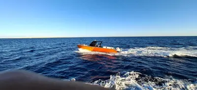 a small boat in the middle of the water at Tai Speedboat orange bay Island- Paradis Island- Dolphin - hula hula Island - Magawish island-etc in Hurghada