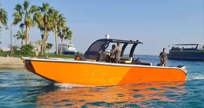 an orange boat in the water with people on it at Tai Speedboat orange bay Island- Paradis Island- Dolphin - hula hula Island - Magawish island-etc in Hurghada
