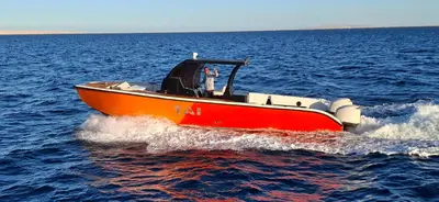 a red and orange boat in the water at Tai Speedboat orange bay Island- Paradis Island- Dolphin - hula hula Island - Magawish island-etc in Hurghada