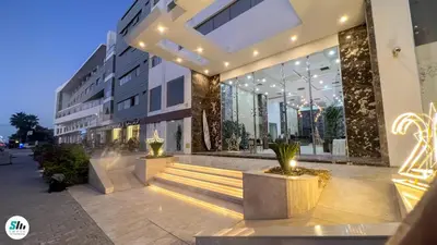 a large building with stairs in front of it at Scandic Hurghada 323 in Hurghada