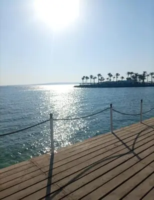 a wooden pier with a view of the ocean at Scandic Hurghada 323 in Hurghada