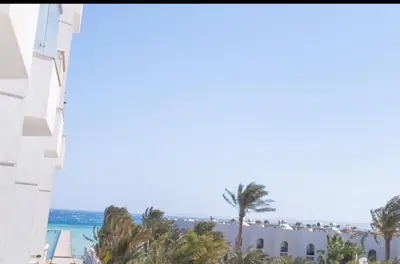 a view of the beach from the balcony of a resort at Scandic Hurghada 323 in Hurghada