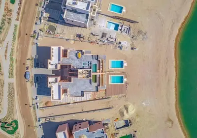 an aerial view of a resort on a beach at Ancient Hill 3BR Gouna Sea View & Priv Roof Pool in El Gouna