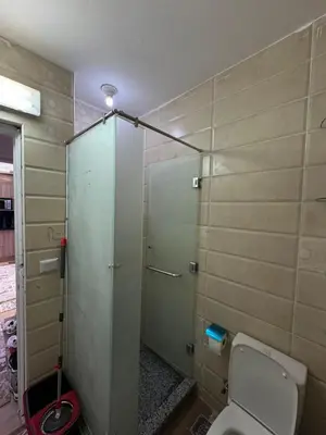a bathroom with a toilet and a glass door at Marsa Alam Port Ghalib in Marsa Alam