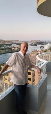 a man standing on top of a balcony at Aswan Nile View Dreams in Aswan