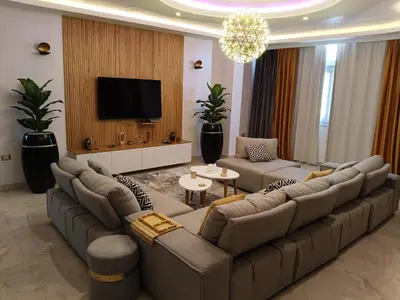a large living room with couches and a flat screen tv at Aswan Nile View Dreams in Aswan