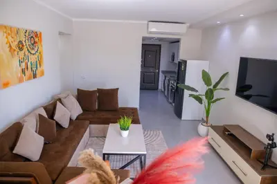 a living room with a couch and a tv at Scandic Resort Hurghada in Hurghada