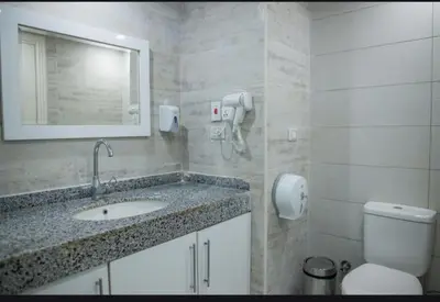 a bathroom with a sink and a toilet and a mirror at Scandic Resort Hurghada in Hurghada