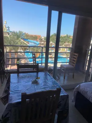 a room with a table and a view of a pool at Mirage bay resort in Hurghada