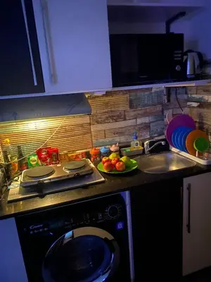 a kitchen with a stove and a sink and a dishwasher at Mirage bay resort in Hurghada