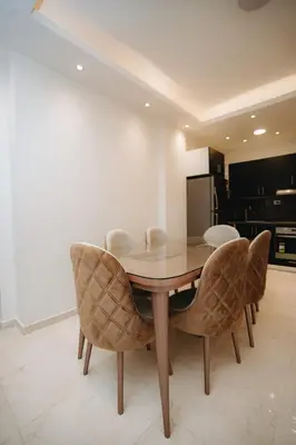 a dining room with a wooden table and chairs at Selina Bay Resort in El Gouna
