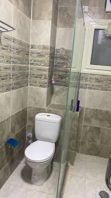 a bathroom with a toilet and a shower at Royal residence in Marsa Alam