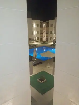 a view of a swimming pool in a building at Royal residence in Marsa Alam