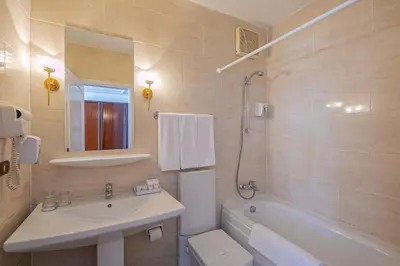 a bathroom with a sink and a toilet and a tub at Marlin Inn Azur Resort in Hurghada